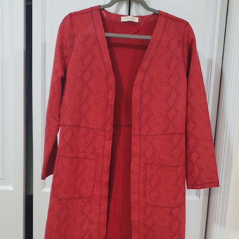 Solitaire long-sleeve open-front cardigan in a rust/red color with two pockets